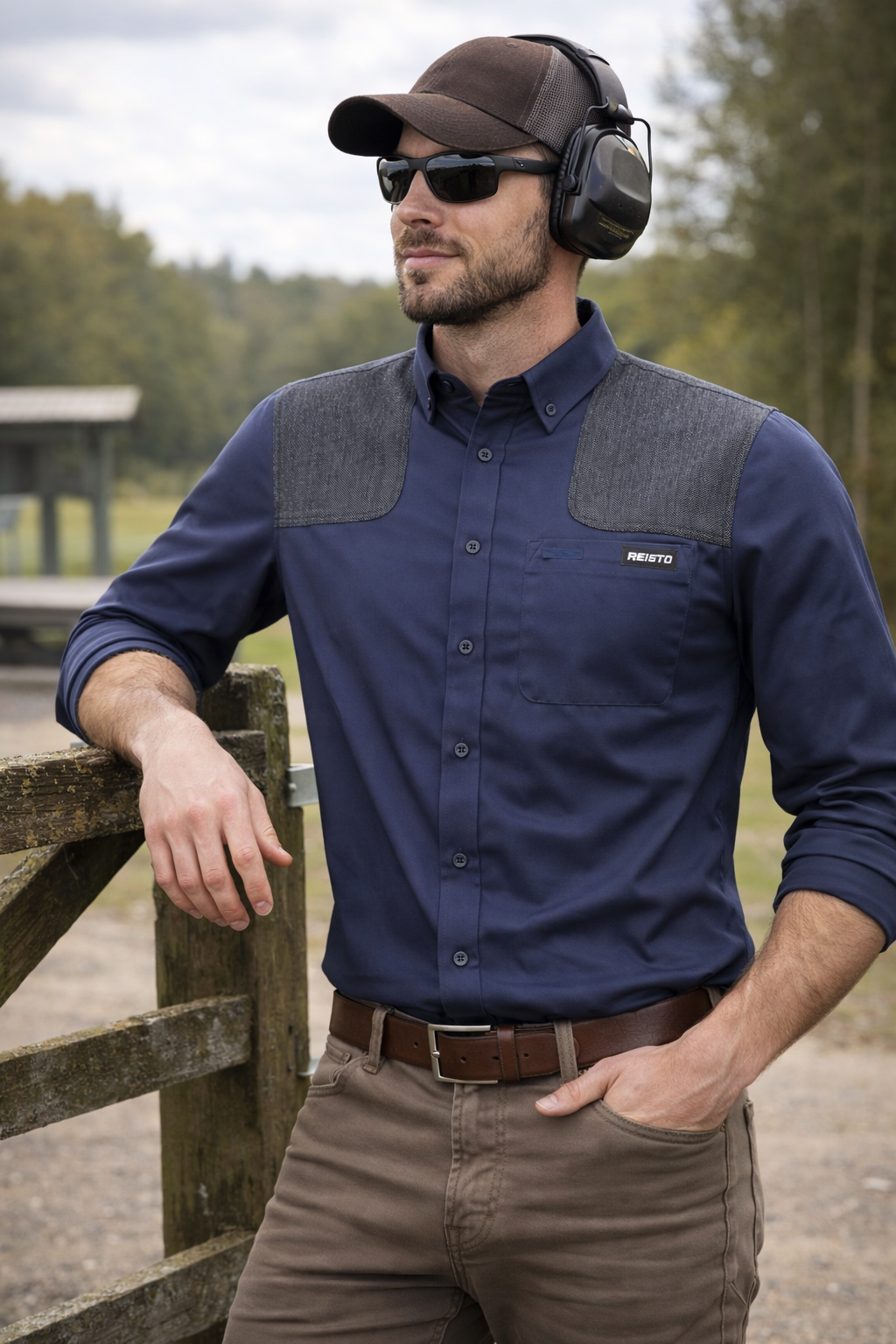 Man leaning on gate in Reisto navy shooting shirt